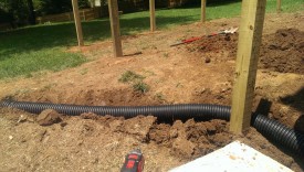 Digging pipe under fence