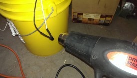 Using heat gun to shrink tubing over connection