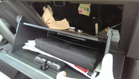 The glove box will fully drop if you open it, pinch the sides, and lower it further