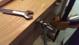 Use two wrenches to break the second nut loose