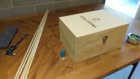 Wine box, test spool of thread, and dowel rod