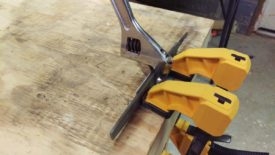 Using clamps and a wrench to bend the angle