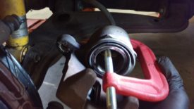 Use a clamp to compress the piston