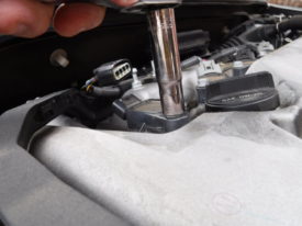 Undo the bolt holding the coil down