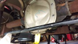 Remove the lower bolts, leaving one or two loosely on the top