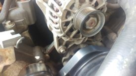 With the tension taken off, the belt slips off the alternator