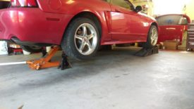 I like to lift the car with the front wheels on wheel ramps and the back wheels on jack stands, making it level