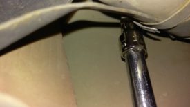 Loosen the hose clamp securing the filter to the car