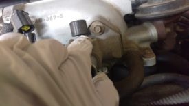 Two small bolts (8mm?) hold the IACV to the intake plenum