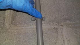 Attaching conduit to wall with anchors
