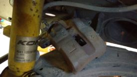 Front caliper sitting on the upper control arm