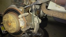 Caliper hanging from a bungee cord to take stress off of the brake line
