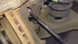 The top caliper bracket bolt