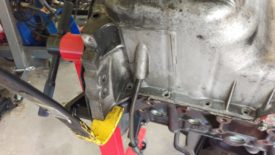 Gently pry the oil pan away from the block