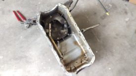Oil pan on ground