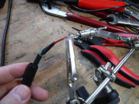 Heat shrink applied, barrel connector housing on, solder blob on pin