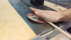 Spin the rod on sandpaper with the drill