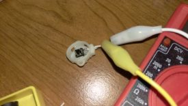 Using alligator clips to hook the bare switch up to a multimeter