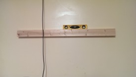 Put in a screw one one side, then use a level before screwing in the other