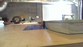 The router bit should be raised so the bearing rides against the template