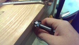 Back out the first nut until it hits the second, then keep unscrewing with a wrench to remove