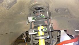 Spring compressed to shorten the coilover for removal