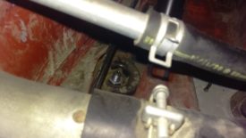 The rear driver coilover upper mount is behind the fuel filler line