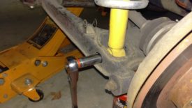 Remove lower shock bolt