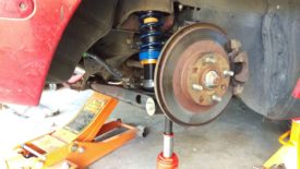 Jack up the corner to ride height to torque properly
