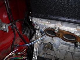 Strap bolts near exhaust manifold