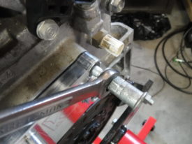 Use the standard two nut trick to remove the stud on each side