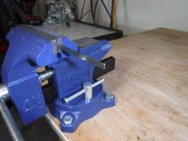 Put it in the vise and cut a about two inches off