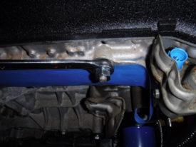 Using a box wrench on the rear nut to remove the studs