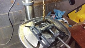 Drilling the central hole in the cap of the mason jar