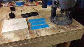 Magnifying readers, router, workpiece, and carpet tape