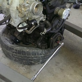 Breaker bar on the crank holds the engine while torquing flywheel