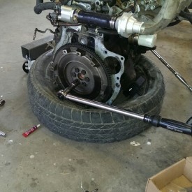 Torque the flywheel bolts incrementally in a star pattern with the breaker bar holding the engine from turning