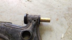 Cover the bushings and brass insert liberally with grease