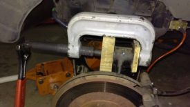 Pressing in new bushings with clamp and blocks of wood