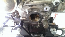 Remove the gasket; note the remaining stud