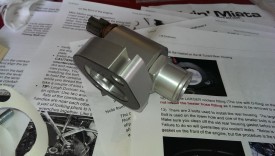 Add the provided stick-on gasket