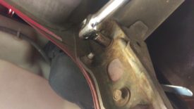 First, undo the tow hook bolts