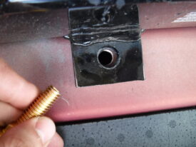 The bolt needs to come out of this hole from the inside
