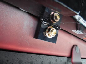 Very carefully thread a nut on without pushing the bolt back through