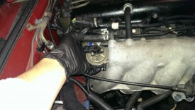 The valve has two bolts, two vacuum lines, and one electrical connector going to it
