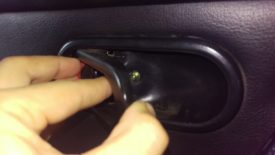 Open the handle partway to get to the screw