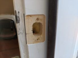 Fresh holes for the latch, just slightly to the left of the old ones