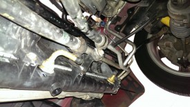 Lower radiator bolt connecting AC lines
