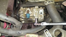 The AC compressor has four mounting bolts, two are pictured