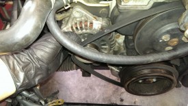Push on the alternator and the belt slips off